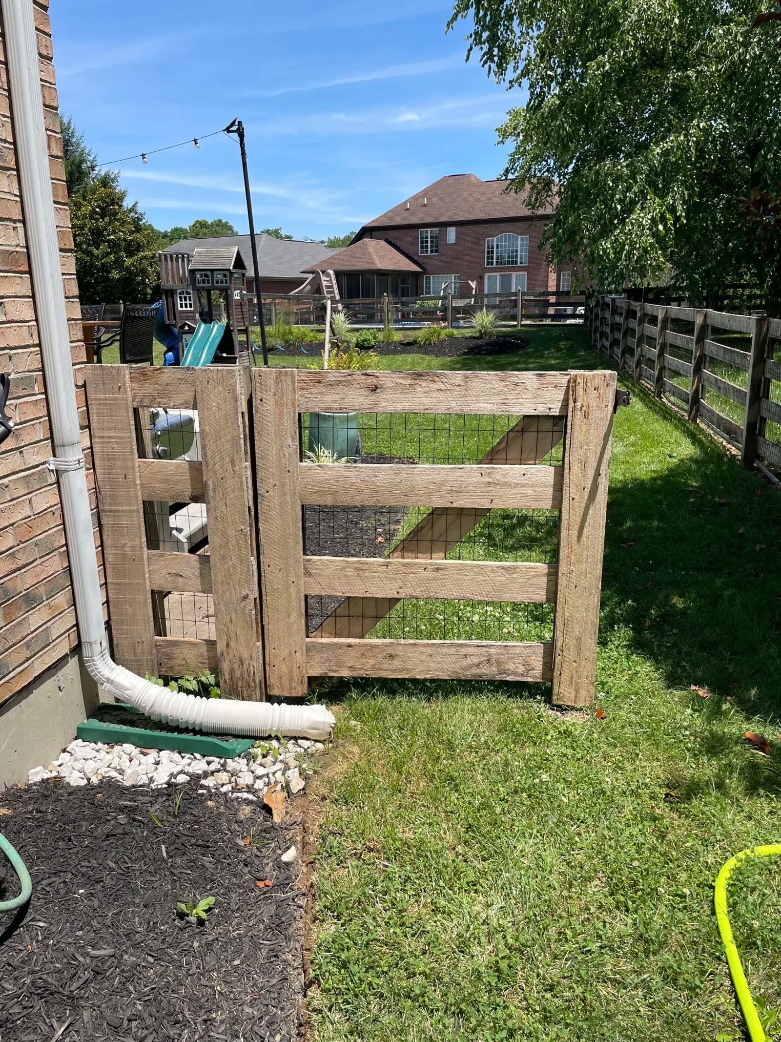 Weathered wood fence and gate in a Northern Kentucky backyard ready for cleaning