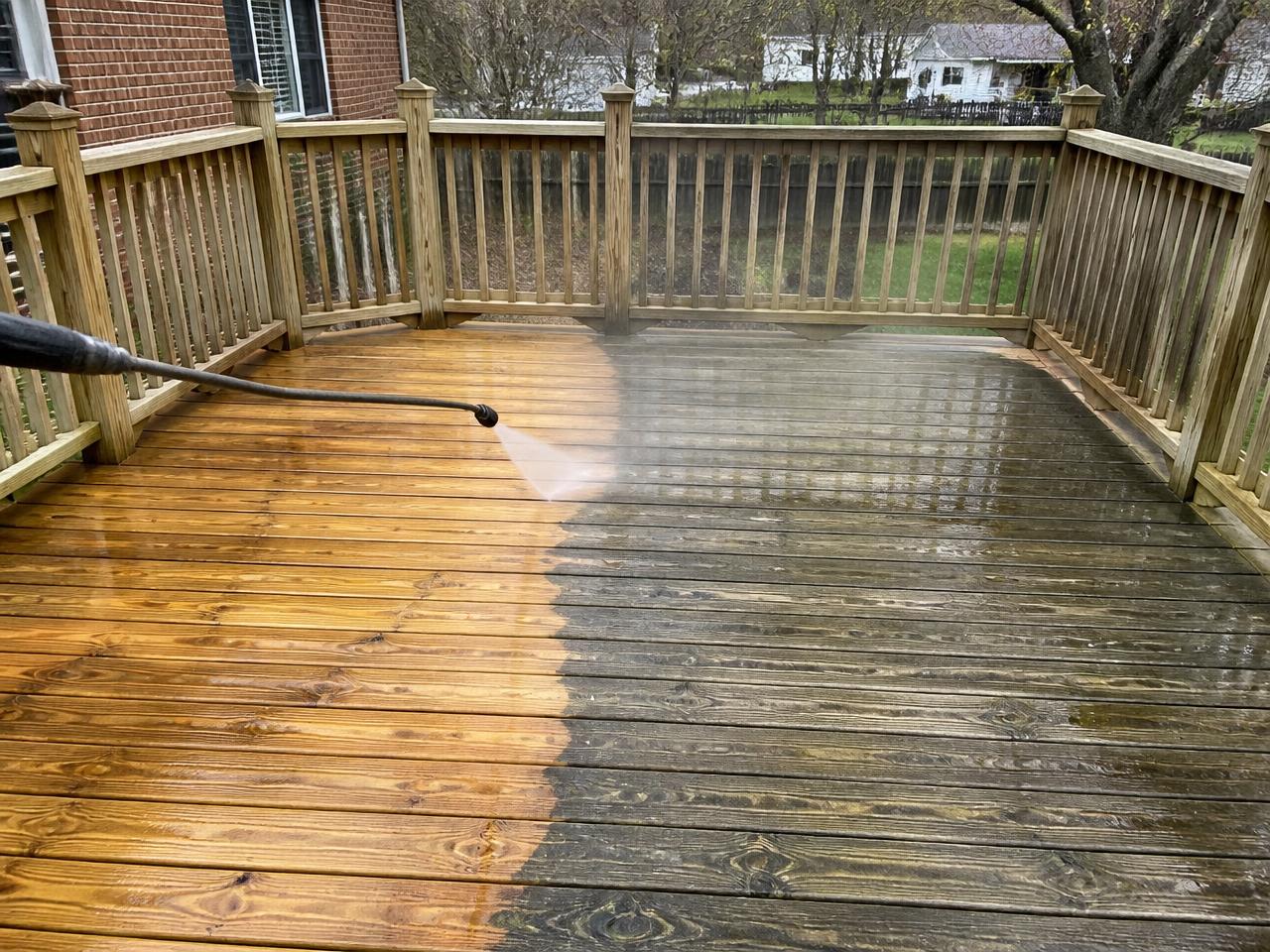 Wood deck being professionally washed showing clean vs dirty
